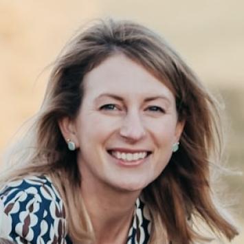 A headshot photo of a woman smiling. 